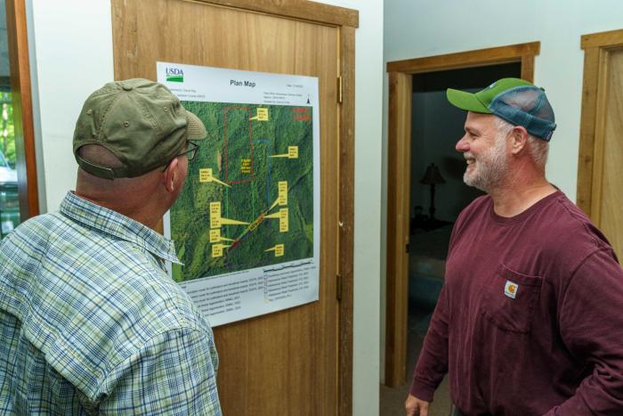 Daniel Shaver (left), Indiana NRCS state forester, and David Ray look at the NRCS plan map for Ray’s forestland in Jackson County, IN during a visit May 24, 2022. Ray purchased 310 acres of forestland in 1995 to use for recreational purposes including hunting, hiking and foraging. Ray enrolled his land in NRCS’ Environmental Quality Incentives Program in 2017 for forest stand improvement and brush management. After the conclusion of his EQIP contract, he enrolled the acres in NRCS’ Conservation Stewar