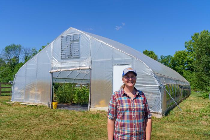 Amy Surburg, the owner of Berry Goods Farm in Morristown, Indiana, (left) is pictured June 27, 2022. Surburg worked with USDA’s Natural Resources Conservation Service (NRCS) to a high tunnel on her farm build using assistance from the Environmental Quality Incentives Program (EQIP). Surburg grows a variety of vegetables, berries and raises chickens on her farm. (NRCS photo by Brandon O’Connor)