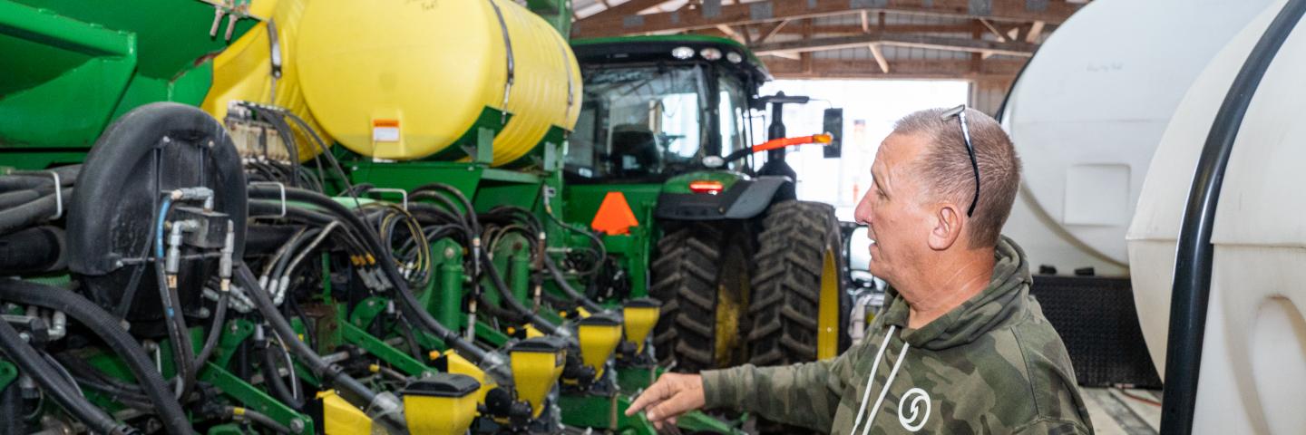 Greg Woll explains the functions of his soybean planter during a visit to his farm in Columbia City, IN July 16, 2021.