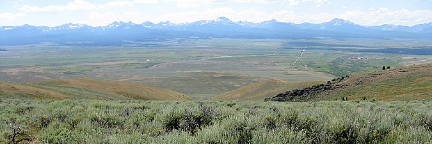 Scenic view of Beaverhead County, MT, sagebrush range with snow-capped mountains in the background