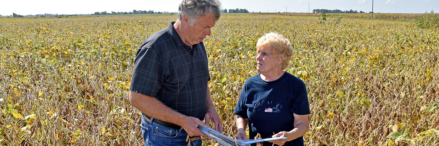 Virginia Reynolds meets with District Conservationist Dennis Schrodt to discuss her conservation plan.