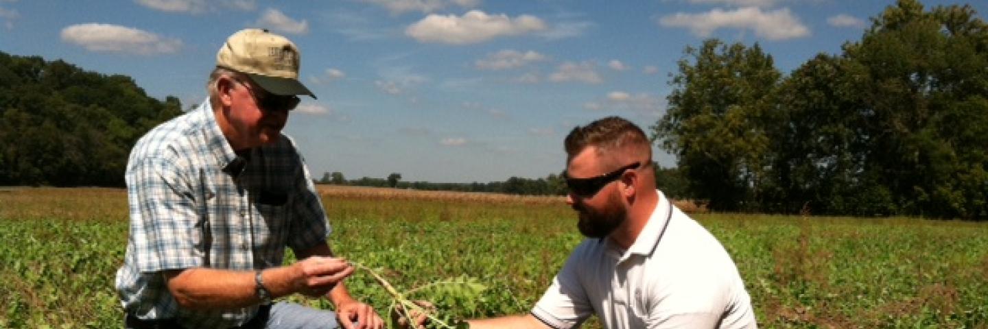Indiana NRCS District Conservationist Evan Smith (right) works with a landowner