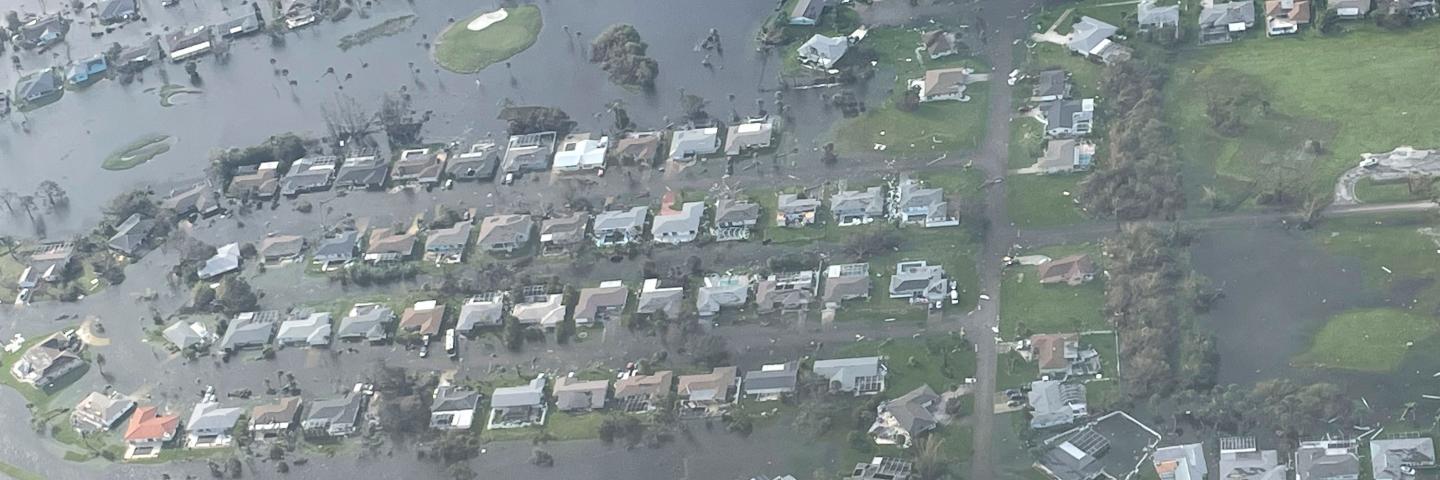 Flooding in Ft Myers Florida shows most houses submerged in water.