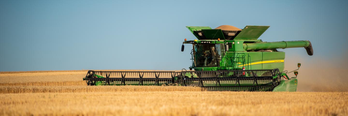 A combine moves across a field during harvest.