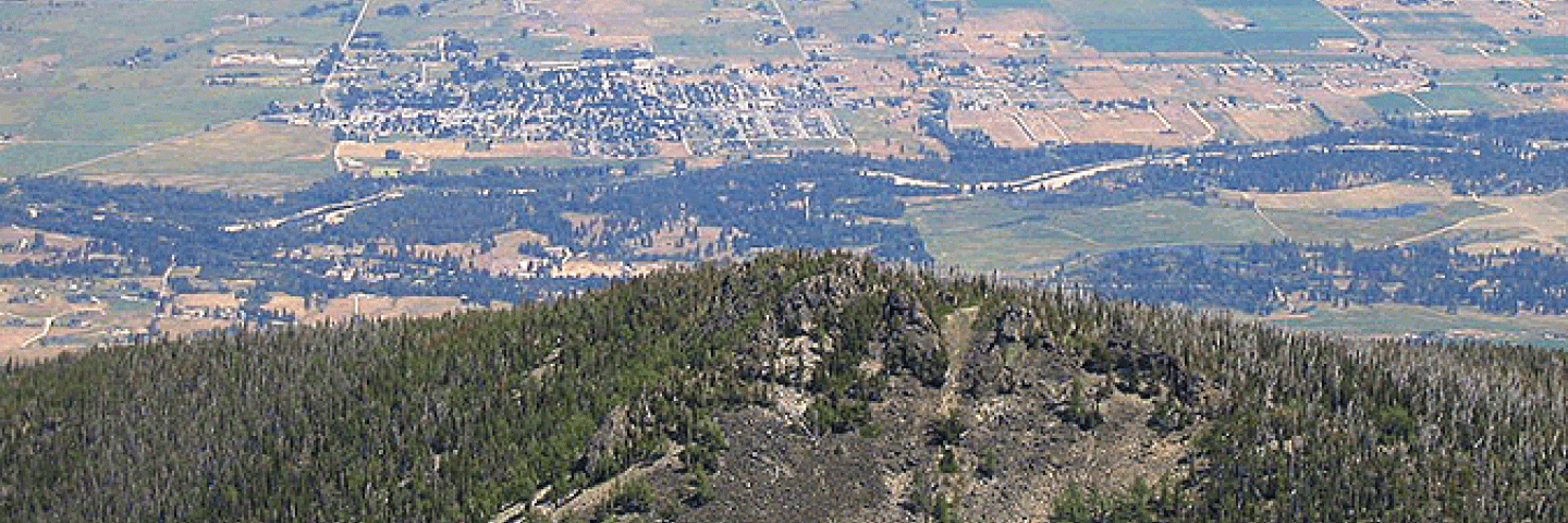 Aerial view of populated valley surrounded by forested mountains, Ravalli County, Montana