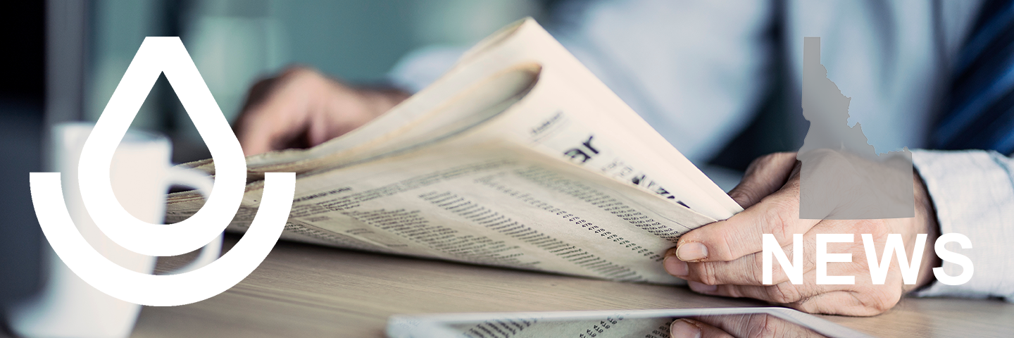 man holding newspaper with NRCS logo on left and state outline on right