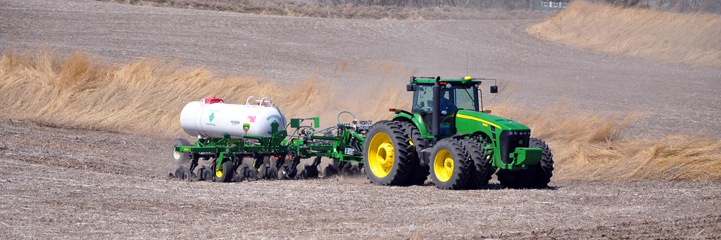 An Iowa farmer applies anhydrous ammonia fertilizer to his soybean field.