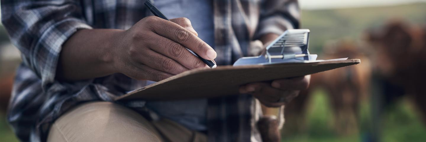 Farmer viewing checklist on clipboard