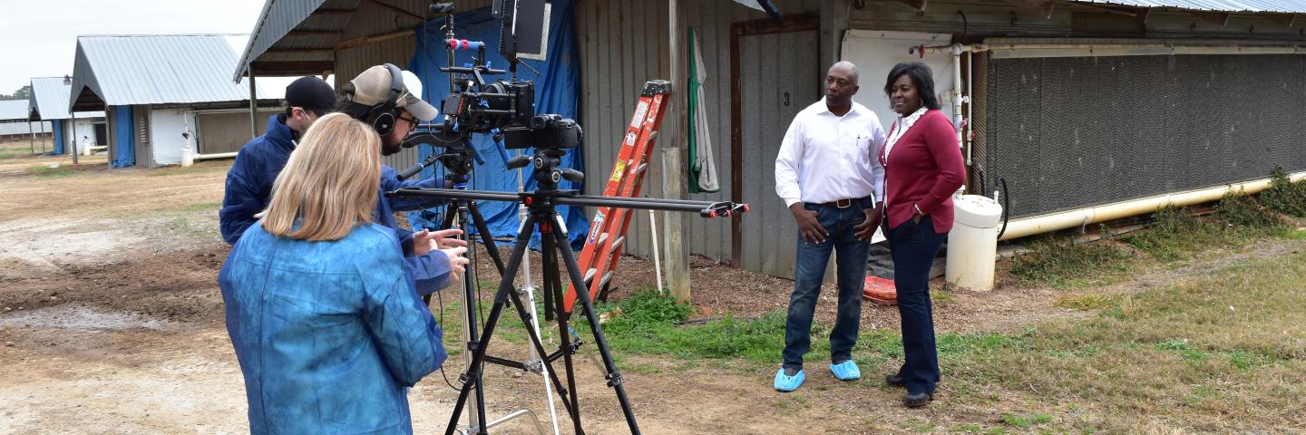 Film crew interviewing poultry farmers