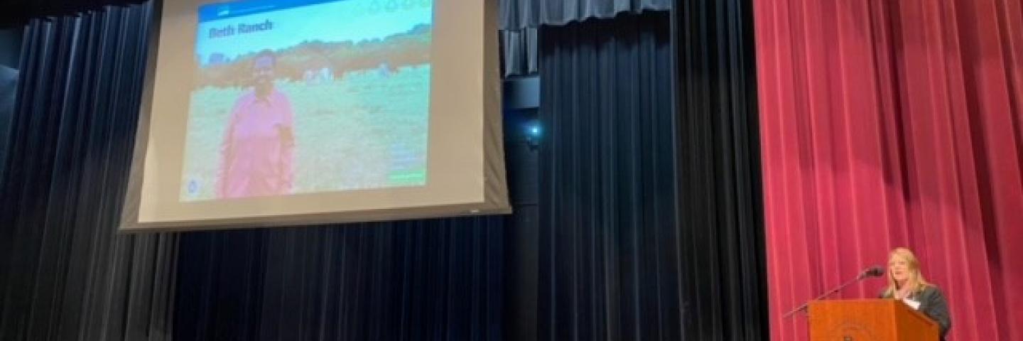 NRCS State Conservationist Kristy Oates speaks to an audience in an auditorium. 