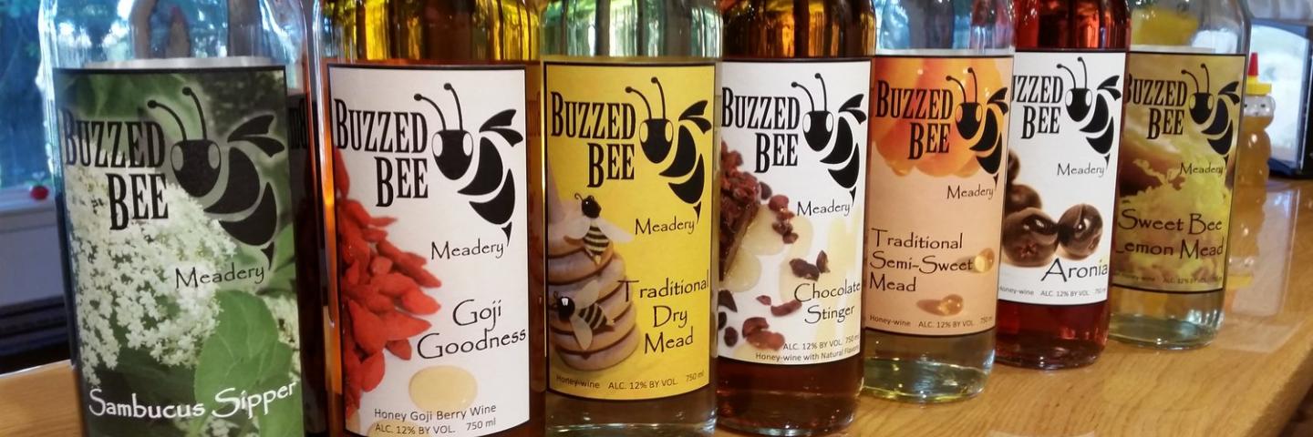 Six bottles of mead lined up.