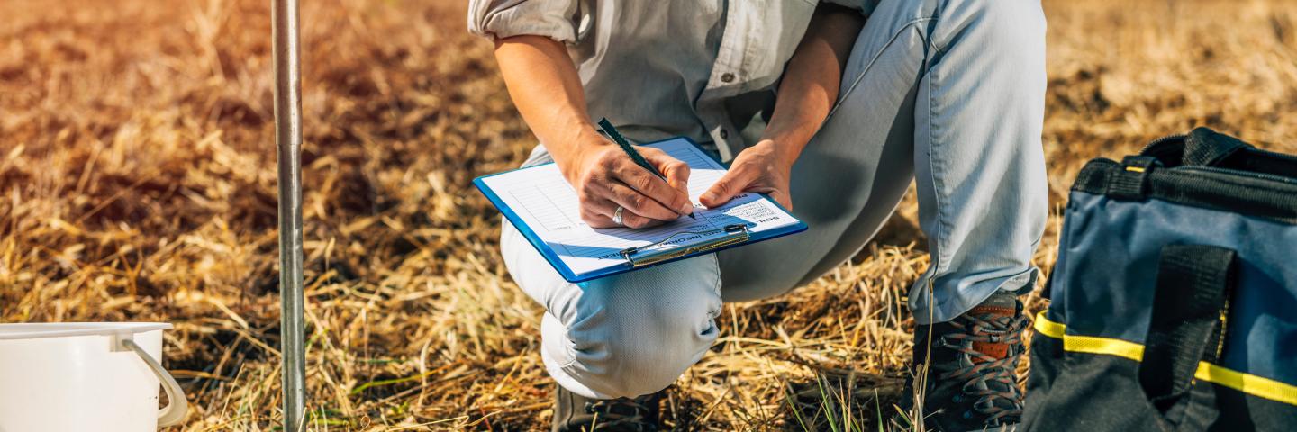 Agronomist taking notes in the field.