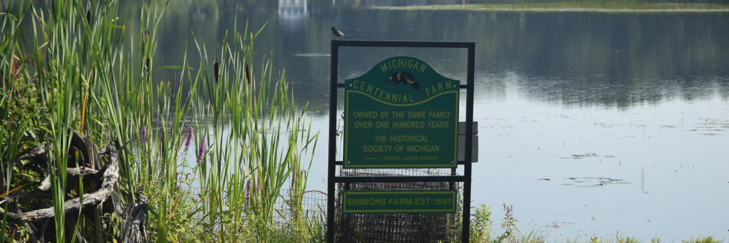 A sign recognizes the Simmons property as a Century Farm on the shore of Middle Lake in Kent County
