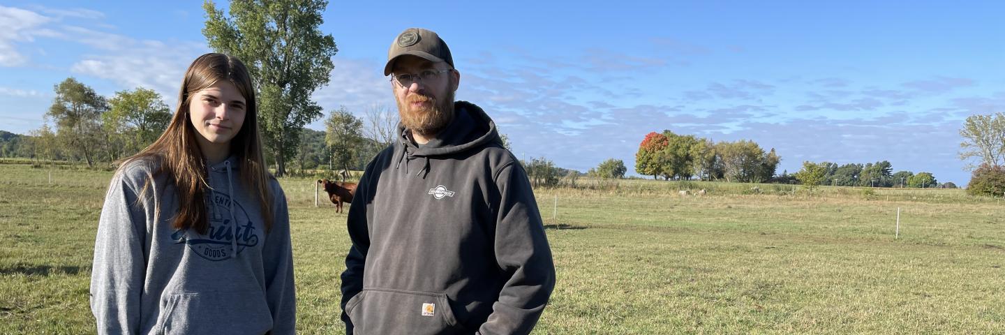 Father and daughter posing in a pasture
