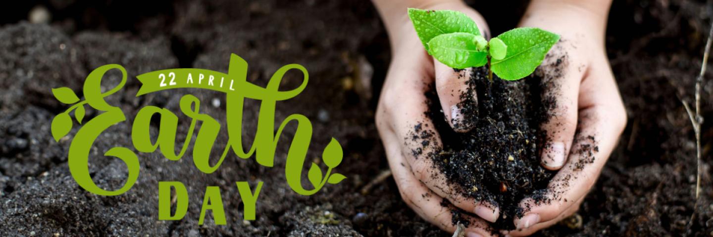 Hands holding soil and a small seedling plant. Text reads Aprill 22 Earth Day