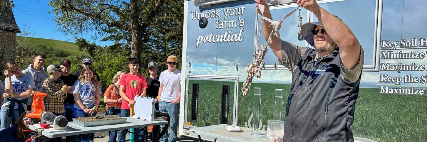 Brandon Davis demonstrates how soil health is measured for FFA students