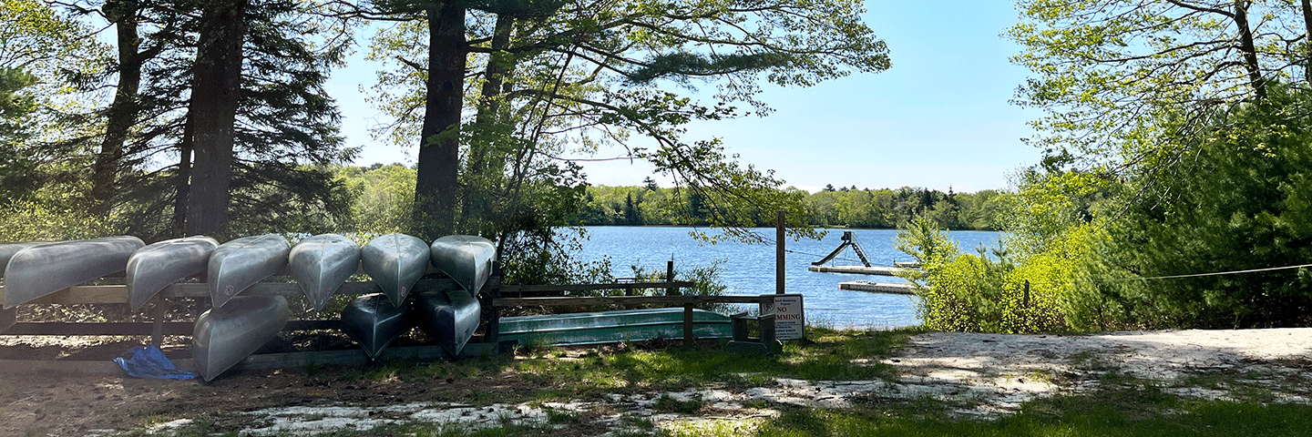 Canoes stored next to Larkins Pond at Camp Hoffman Girl Scout Camp, South Kingstown, Rhode Island.