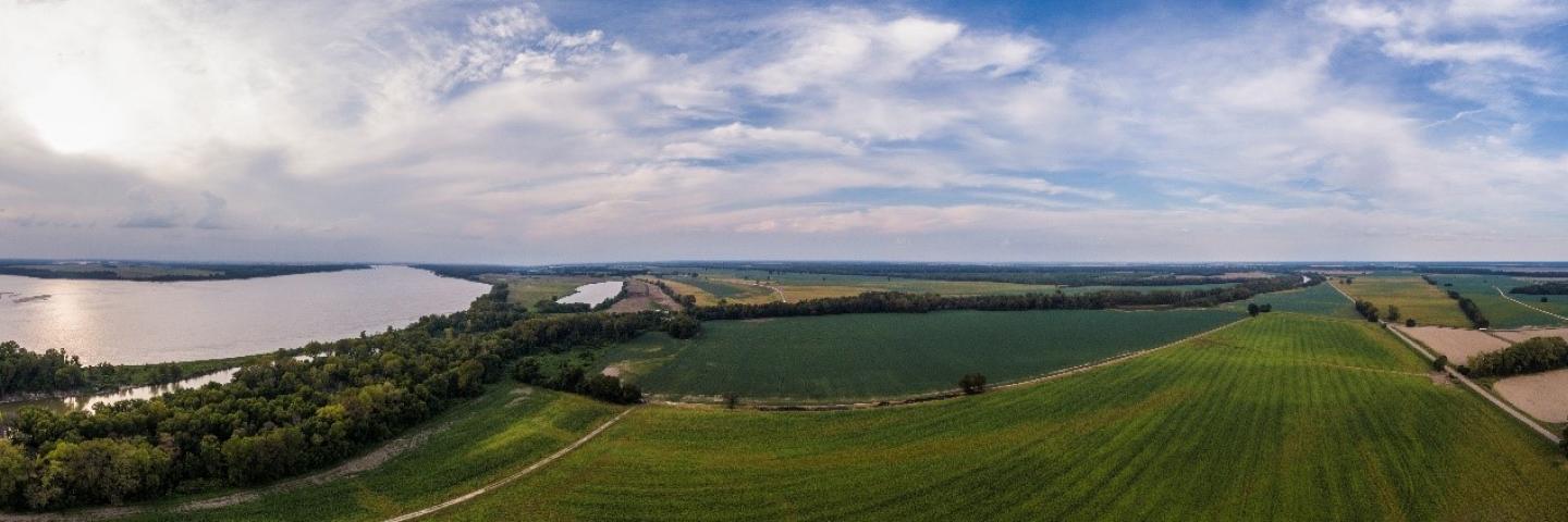 panoramic view of lake, forest, cropped fields
