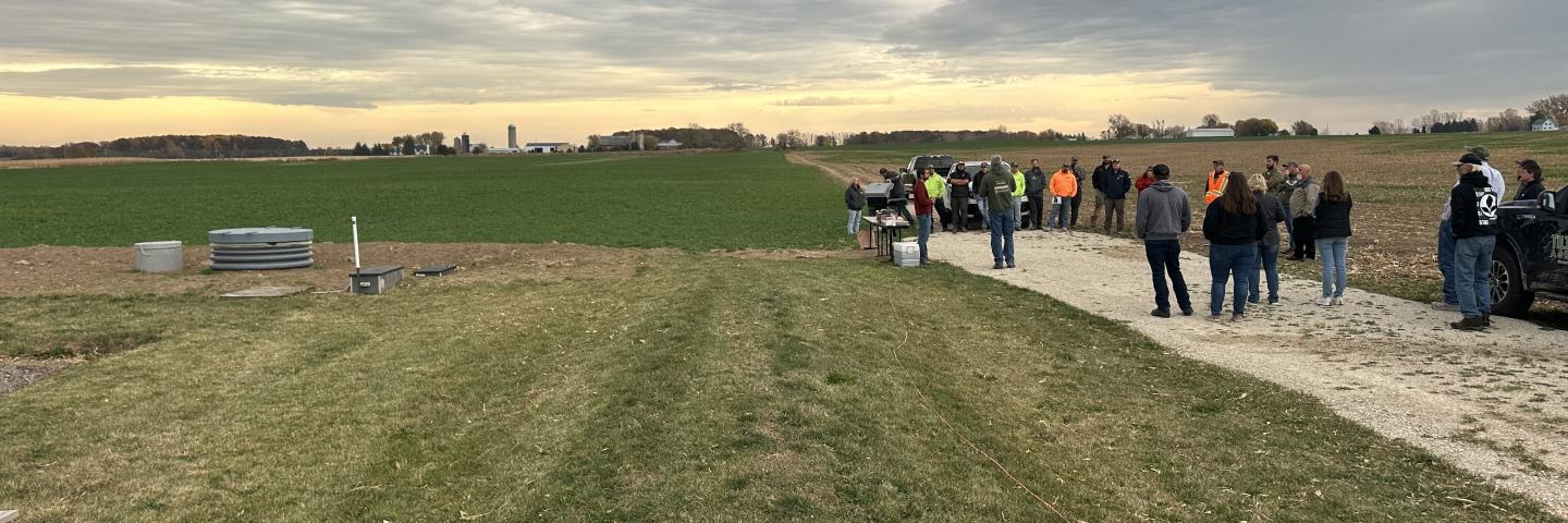 A view looking east of the Phosphorus Removal System and Denitrifying Bioreactor. Components include water control structures, HDPE access manhole to monitor flow, concrete holding tank riser, and diversion embankment.