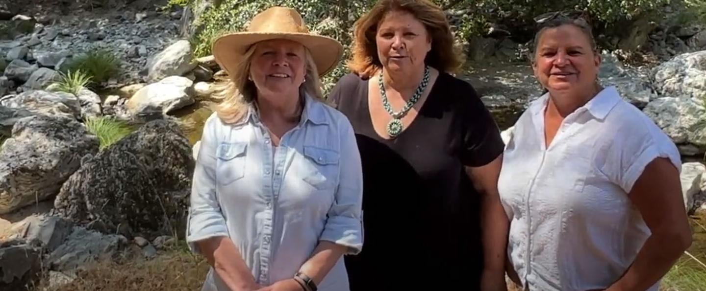  Susie, Merry and Nancy Calhoun standing on a streambank in front of rocks