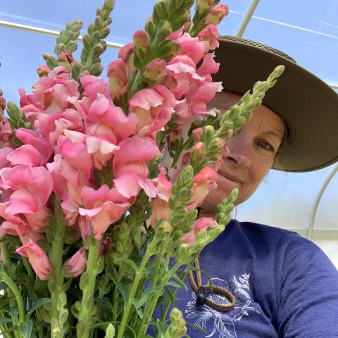 Jessica Gates holds flowers grown in a High Tunnel