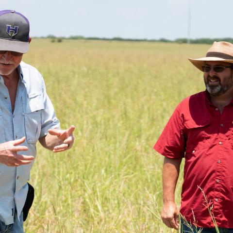 Chuck Emerson visits with Jeff Brister, District Conservationist with the USDA Natural Resources Conservation Service, in the field at his ranch.
