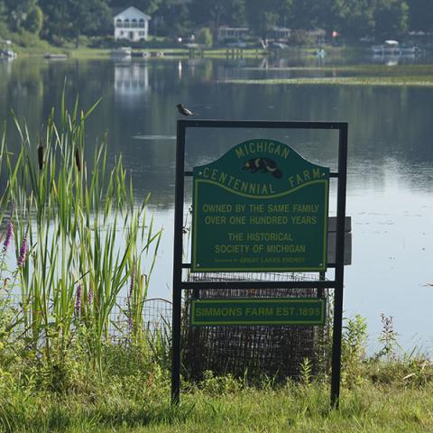 A sign recognizes the Simmons property as a Century Farm on the shore of Middle Lake in Kent County