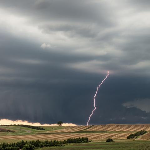 Supercell thunderstorm with wall cloud and lightning