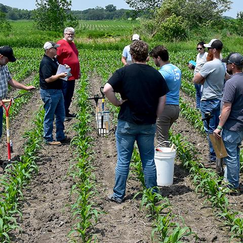 Jason Steele, left, looks at soil probe results during soil health training in southeast Iowa.