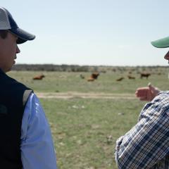 Cody Halfmann (left) and local NRCS employee Wade Day (right) talking