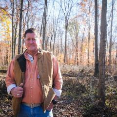 Tim Adams walks through his timberland in Martinsville, Indiana.