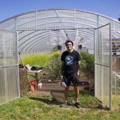 Urban Ag producer and owner of Peak of Abundance Farms Brandon Gerard poses in front of his high tunnel in Spokane Valley, Wash.