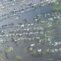 Flooding in Ft Myers Florida shows most houses submerged in water.