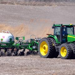 An Iowa farmer applies anhydrous ammonia fertilizer to his soybean field.
