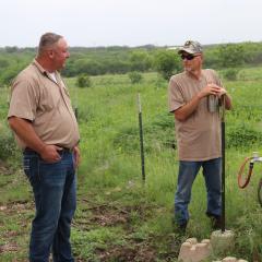 Jason Katcsmorak (left), NRCS district conservationist in Floresville, visits with Army veteran, Doug Havemann (right), co-owner of Mesquite Field Farm in Nixon, about conservation efforts on his farm.