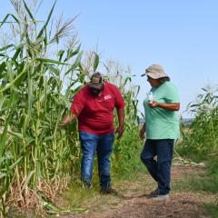 NRCS employee checks on crops growing with NRG Dewey Prairie Garden Manager, Debbie Glaze.