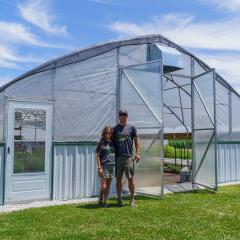 Carrie Kleiman (left), the owner of Floral Compass Flower Farm in Fountaintown, Indiana, and her husband Nick Kleiman, pictured at the farm on June 28, 2022.