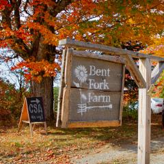 The sign for Bent Fork Farm hangs framed by autumn foliage in Bethlehem, N.H. September 29, 2020. Bent Fork Farm has worked with NRCS to hone organic practices and increase their production to help feed local communities. (Natural Resources Conservation Service photo by Jeremy J. Fowler, Public Affairs Specialist, NRCS, N.H)