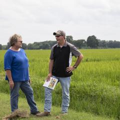 An NRCS employees speaks with a producer. 