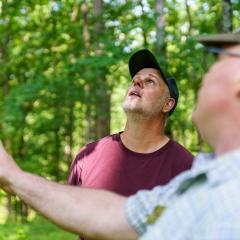 David Ray (left) and Daniel Shaver, Indiana NRCS state forester, talk about ways to improve Ray’s forestland in Jackson County, IN during a tour May 24, 2022. Ray purchased 310 acres of forestland in 1995 to use for recreational purposes including hunting, hiking and foraging. Ray enrolled his land in NRCS’ Environmental Quality Incentives Program in 2017 for forest stand improvement and brush management. After the conclusion of his EQIP contract, he enrolled the acres in NRCS’ Conservation Stewardshi