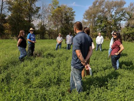 Group of people in a pasture.