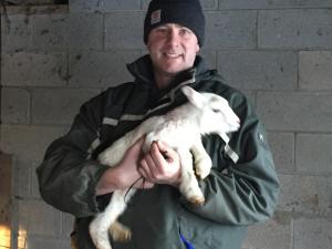 Producer holding lamb