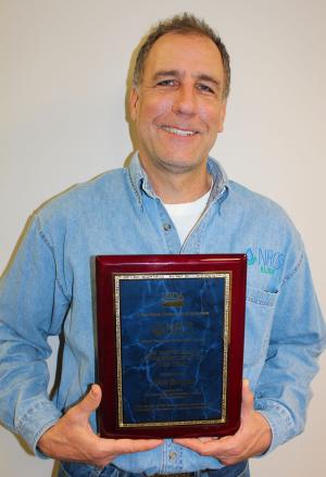 Matt Bunger holding award