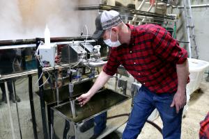 Nate Shattuck working at the evaporator at Shattuck's Sugarhouse