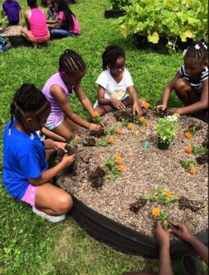 Children learning over People's Garden exhibit
