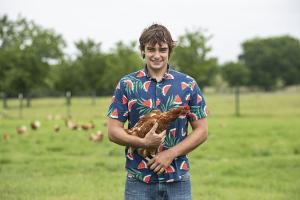 Andrew Benson holding a chicken near Waco, Texas.