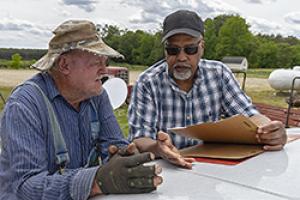An NRCS conservationist reviews a plan with a landowner.