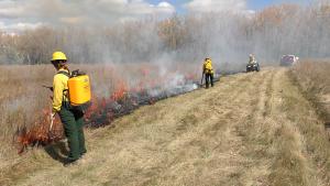 A fire crew watches over a prescribed burn in North Dakota. (Photo: The Nature Conservancy)