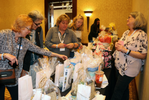 2020 Rhode Island Women in Agriculture conference attendees peruse the basket raffle prizes.