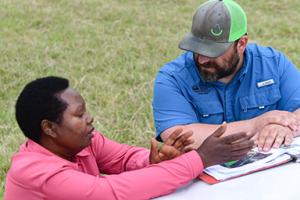 Elizabeth Thinwa and NRCS District Conservationist Clete Vanderburg work together to develop a conservation plan for Beth Ranch.